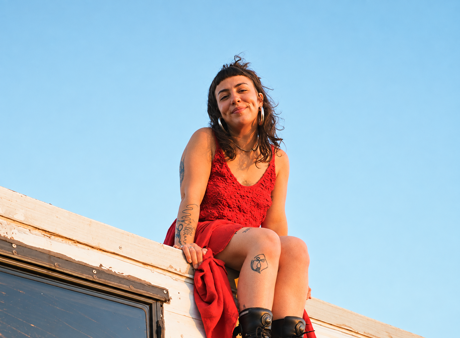 Andie photographed on a rooftop at golden hour